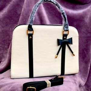 Beautiful new purse with cute black detail bow.